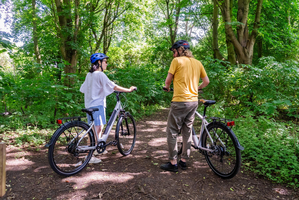 Falcon Horizon electric hybrid bikes - riders on a woodland path — view 15