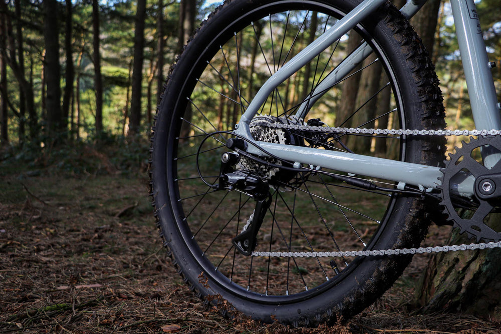 Claud Butler Ridge 1.0 Electric Mountain Bike - Shimano Acera 8-speed drivetrain in the woods — view 27