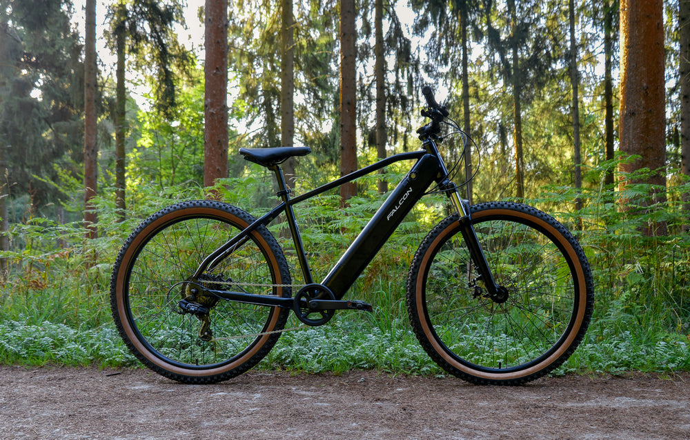 Falcon Turbine Electric Mountain Bike - side profile in the forest — view 12