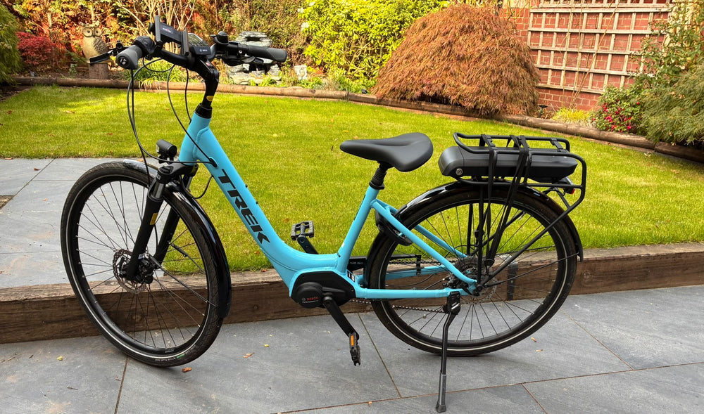 Trek Verve+ 2 Lowstep e-bike non-drive side view showing step-through frame, kickstand and Bosch battery — view 2