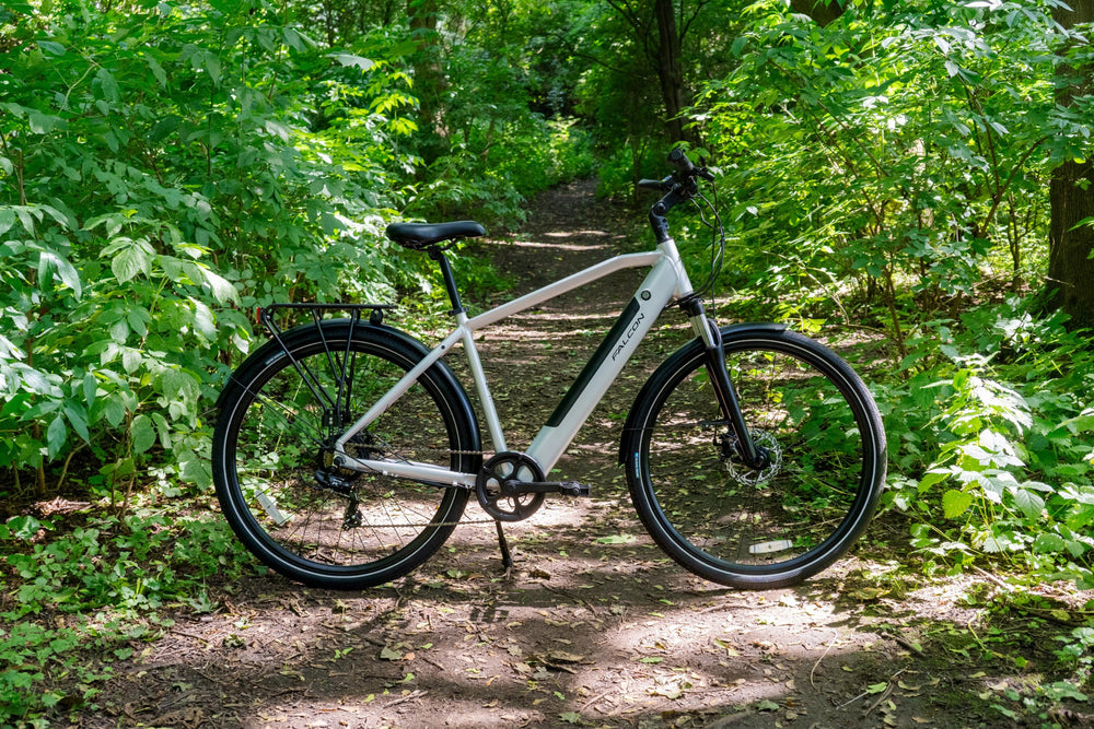 Falcon Horizon Cross Bar Electric Hybrid Bike - side profile on a woodland path — view 12