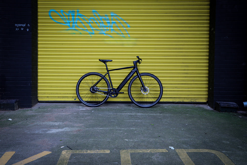 Falcon Zone Electric Hybrid Bike - side profile against a yellow shutter — view 27