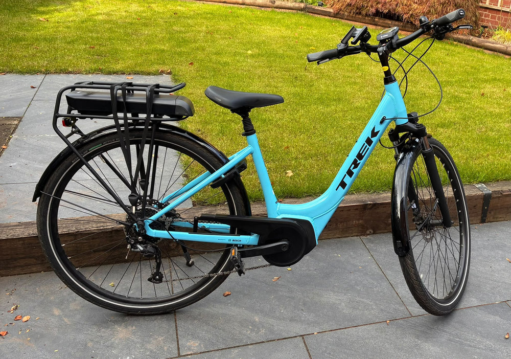 Trek Verve+ 2 Lowstep electric hybrid bike in Azure Blue, size Small, drive side view with rear rack battery and mudguards — view 1