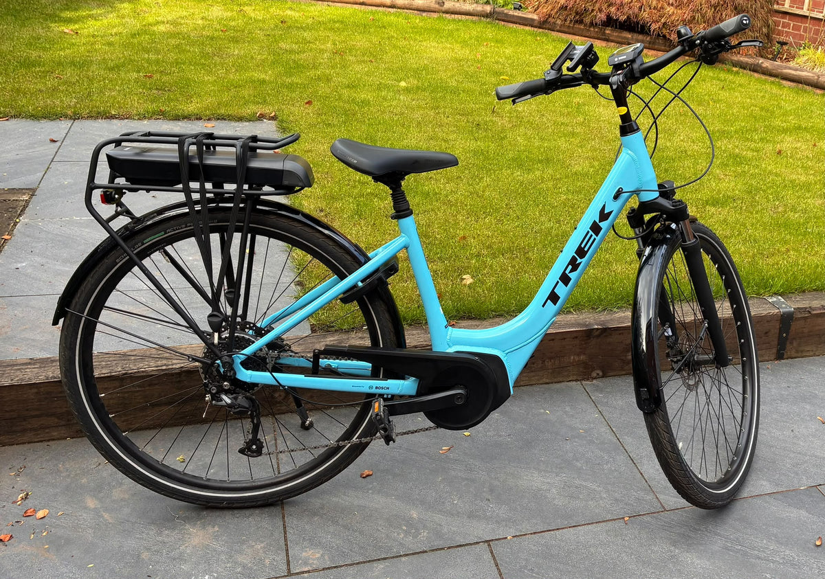 Trek Verve+ 2 Lowstep electric hybrid bike in Azure Blue, size Small, drive side view with rear rack battery and mudguards